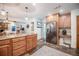 Bright kitchen with stainless steel refrigerator, wood cabinets, stone countertops, and a decorative area rug at 4825 Luce Rd, Lakeland, FL 33813