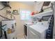 Well-lit laundry room featuring a washer, dryer, and ample shelving space for all your needs at 4825 Luce Rd, Lakeland, FL 33813