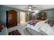Main bedroom featuring a large bed, ceiling fan, and armoire at 4825 Luce Rd, Lakeland, FL 33813