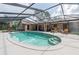 A sparkling swimming pool surrounded by a screened enclosure and beautiful outdoor seating area at 4825 Luce Rd, Lakeland, FL 33813