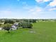 Sweeping aerial shot of the property highlighting the home, outbuildings, and vast green pastures at 511 Hickory Hammock Rd, Lake Wales, FL 33859