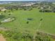 Expansive pastureland features a charming pond, enhancing the natural beauty at 511 Hickory Hammock Rd, Lake Wales, FL 33859
