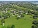 Spacious aerial view of a home surrounded by green fields and a bordering tree line at 511 Hickory Hammock Rd, Lake Wales, FL 33859