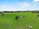 Breathtaking aerial view of the sprawling property with lush green fields and distant water feature at 511 Hickory Hammock Rd, Lake Wales, FL 33859