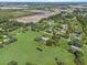 Aerial shot features a home with green pasture, with new construction in the distance at 511 Hickory Hammock Rd, Lake Wales, FL 33859
