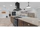 Open kitchen boasts granite countertops, gas range, and modern hood at 511 Hickory Hammock Rd, Lake Wales, FL 33859