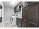 Laundry room features modern washer/dryer and dark cabinets for storage at 511 Hickory Hammock Rd, Lake Wales, FL 33859