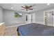 Bright main bedroom features a ceiling fan, wood floors, and access to the bathroom at 511 Hickory Hammock Rd, Lake Wales, FL 33859
