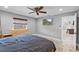 Bright main bedroom boasts a ceiling fan, wood floors, and natural light from the large window at 511 Hickory Hammock Rd, Lake Wales, FL 33859