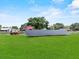 Expansive property featuring a home, red barn, and solar panels amid lush green fields at 511 Hickory Hammock Rd, Lake Wales, FL 33859