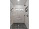 Stylish, tiled shower features dual shower heads and recessed shelving at 511 Hickory Hammock Rd, Lake Wales, FL 33859