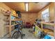 Workshop with wood walls, concrete floors, shelves, and bicycle at 511 Hickory Hammock Rd, Lake Wales, FL 33859