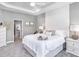 Serene main bedroom featuring neutral tones, a tray ceiling, and access to the ensuite bathroom and walk-in closet at 5418 Duxford Cir, St Cloud, FL 34771