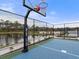 Community sport court, pond view, framed by fences and lush greenery for outdoor activities and recreation at 5418 Duxford Cir, St Cloud, FL 34771