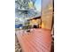 This outdoor backyard offers a wooden deck with a grill, an umbrella, and a table with chairs at 5619 Antler Trl, Lakeland, FL 33811