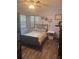 This bedroom offers a dark wood floor and includes a ceiling fan, lots of natural light, and some wall decor at 5619 Antler Trl, Lakeland, FL 33811