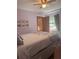 This bedroom offers lots of natural light and includes a ceiling fan and a frame of pictures on the wall at 5619 Antler Trl, Lakeland, FL 33811