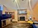 Cozy living room featuring a brick fireplace, wood-look flooring, and vaulted ceilings at 5619 Antler Trl, Lakeland, FL 33811
