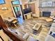 Open concept living room with dining area, fireplace, wood floors, and natural light at 5619 Antler Trl, Lakeland, FL 33811