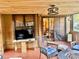 This screened patio offers a wood ceiling and features a sliding glass door and a TV at 5619 Antler Trl, Lakeland, FL 33811