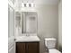 Bathroom featuring a single sink vanity with marble countertop, mirror, and a toilet at 5776 Freshwater Canyon Dr, St Cloud, FL 34771