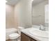 Bathroom featuring a single sink vanity with marble countertop, mirror, and a toilet at 5776 Freshwater Canyon Dr, St Cloud, FL 34771