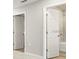 Bright hallway with two doors, one leading to a bathroom with shower/tub combination at 5776 Freshwater Canyon Dr, St Cloud, FL 34771