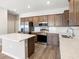 Spacious kitchen featuring stainless steel appliances, island, and wood cabinets at 5776 Freshwater Canyon Dr, St Cloud, FL 34771