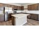Modern kitchen featuring stainless steel appliances, sleek countertops, an island, and wood cabinets at 5776 Freshwater Canyon Dr, St Cloud, FL 34771
