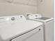 Close up on Samsung washer and dryer with wire shelf on the wall in the laundry room at 5776 Freshwater Canyon Dr, St Cloud, FL 34771