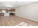 Open-concept living space with kitchen island and stainless steel appliances and hardwood flooring at 5776 Freshwater Canyon Dr, St Cloud, FL 34771