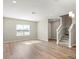 Hardwood flooring, natural light from window, and staircase leading to upper level at 5776 Freshwater Canyon Dr, St Cloud, FL 34771