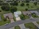 Aerial view of a single-Gathering home with a well-maintained lawn and brick driveway at 6086 Swallow Dr, Lakeland, FL 33809