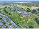 Expansive aerial view of community with a golf course, pool, clubhouse, and lush landscaping at 6086 Swallow Dr, Lakeland, FL 33809