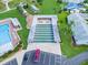 Aerial view of community shuffleboard courts adjacent to pool with covered seating and parking at 6086 Swallow Dr, Lakeland, FL 33809