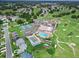Community aerial showcasing a pool, shuffleboard courts, pickleball courts, clubhouse, and parking areas at 6086 Swallow Dr, Lakeland, FL 33809