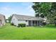 Well-maintained backyard with a screened-in porch, manicured lawn, and carefully placed landscaping at 6086 Swallow Dr, Lakeland, FL 33809