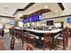 Upscale bar area features multiple TVs, ample seating, and a marble countertop bar for a relaxing atmosphere at 6086 Swallow Dr, Lakeland, FL 33809
