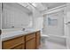 Bathroom featuring a single sink vanity, a shower-tub combo, and tile flooring at 6086 Swallow Dr, Lakeland, FL 33809