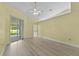 Spacious bedroom with laminate floors, ceiling fan, and sliding glass door at 6086 Swallow Dr, Lakeland, FL 33809