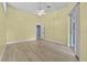 Spacious bedroom with laminate floors, ceiling fan, and sliding glass door at 6086 Swallow Dr, Lakeland, FL 33809