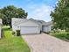 Inviting one-story home with a brick driveway and lush front lawn at 6086 Swallow Dr, Lakeland, FL 33809