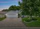 Charming home with well-manicured landscaping, a brick driveway, and a welcoming front entrance at 6086 Swallow Dr, Lakeland, FL 33809