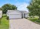 Charming single-story home featuring a brick driveway and manicured landscaping at 6086 Swallow Dr, Lakeland, FL 33809