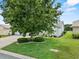Well-manicured front yard with lush green lawn and mature tree landscaping at 6086 Swallow Dr, Lakeland, FL 33809