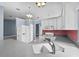 Bright eat-in kitchen boasts a white refrigerator, modern appliances, and updated lighting at 6086 Swallow Dr, Lakeland, FL 33809