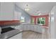 The eat-in kitchen features views of the backyard, white cabinets, and stainless steel appliances at 6086 Swallow Dr, Lakeland, FL 33809