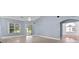 Open living area with large windows and sliding door to the backyard and golf view at 6086 Swallow Dr, Lakeland, FL 33809
