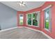 Bright living room featuring large windows with golf course views and modern ceiling fan at 6086 Swallow Dr, Lakeland, FL 33809