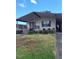 Charming home features a covered entrance, complemented by a lush green lawn and colorful flowerbeds at 612 Forest Lake Dr, Lakeland, FL 33809
